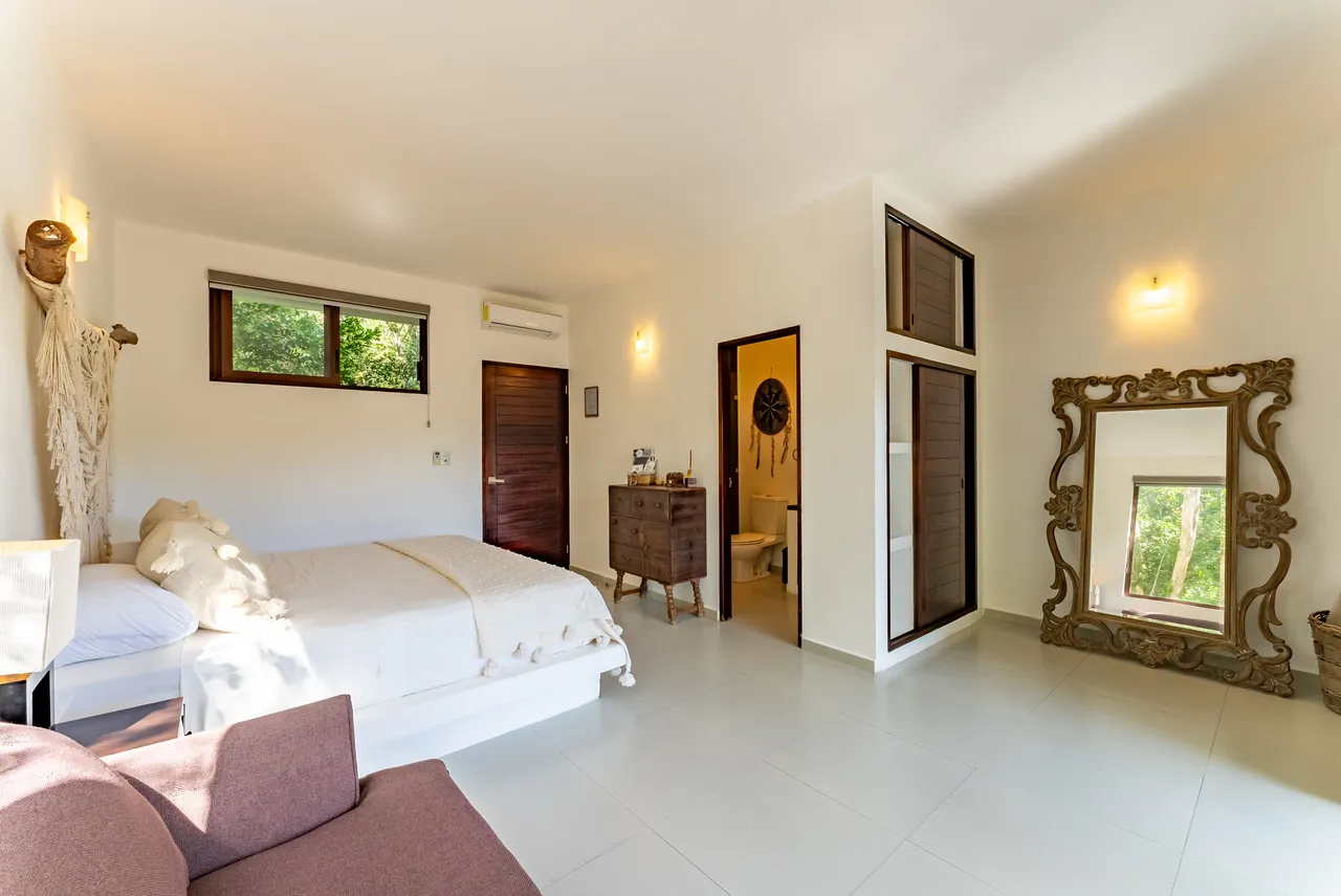Bassé Clinic Bedroom — natural finishings and balcony access